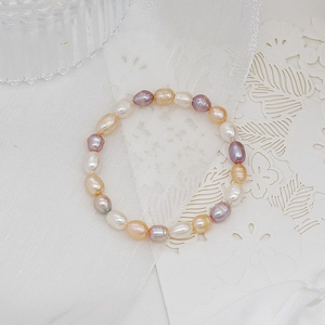 Detailed macro view of natural baroque freshwater pearls on an elastic bracelet