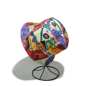 Detail view of colorful graffiti bucket hat with abstract street art print on display stand