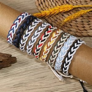 Handmade braided cotton cord bracelets in multiple colors on a natural rustic background