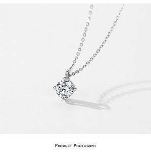Macro detail of classic S925 sterling silver solitaire pendant necklace with four-prong setting