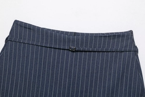 Detail of navy blue pinstripe skort waist with metal buckle and hidden side zipper