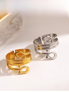 Detail of gold and silver stainless steel Ankh cross rings with polished finish