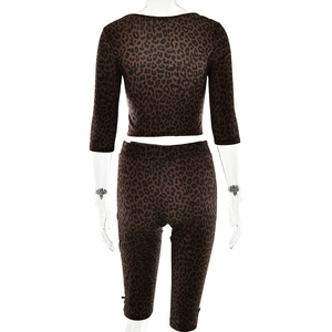 Rear view of women's leopard print two-piece set featuring short top and tight cycling shorts