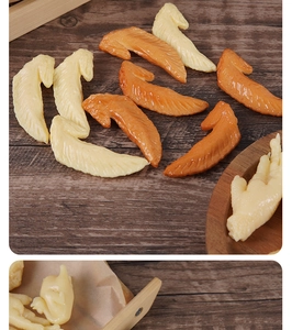 Macro shot of realistic food models featuring chicken wings with lifelike skin texture