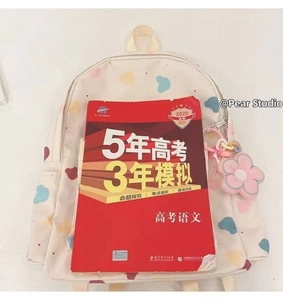 Capacity view of beige cartoon backpack with floral charm showing spacious storage space