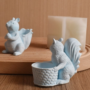 Detailed view of light blue squirrel resin crafts with storage baskets on a wooden tray