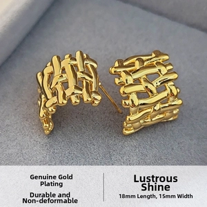 Macro detail of gold-plated C-shaped earrings with woven texture, 18mm length and 15mm width