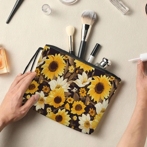 Floral makeup bag with sunflower print, zipper closure, and wrist strap for toiletries