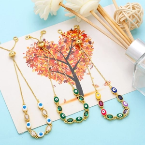 Detail of adjustable evil eye bracelets with colorful enamel beads and golden chain