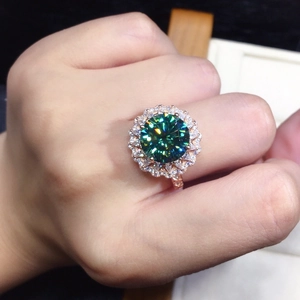 Luxury rose gold ring featuring a green moissanite center stone and halo diamonds