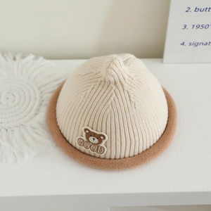 Knitted baby pointed hat with bear patch and rolled brim in cream and brown