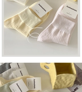 Detailed close-up of ribbed texture and soft pastel colors of combed cotton socks