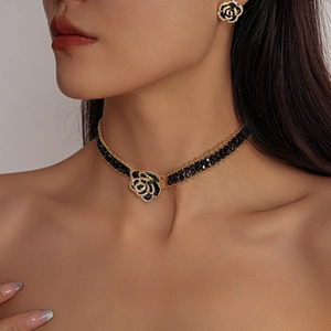 Detail of camellia choker with black beaded chain and sparkling diamond edges