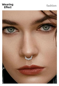 Detailed close-up of a silver septum ring with a fan-shaped zircon crown on a model