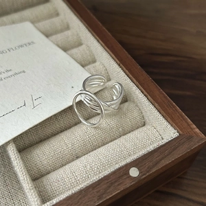 Detailed view of S925 sterling silver multilayer ring inside a wooden jewelry box