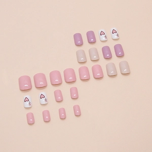 Pink and purple press-on nails set with red heart designs on a neutral background