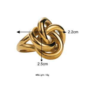 Detail view of 18k gold knotted ring with dimensional measurements 2.2cm and 2.5cm