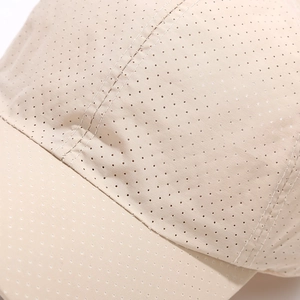 Close-up of beige quick-dry fabric with breathable micro-perforations on a sun cap