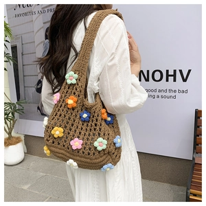 Close-up of handmade crochet tote bag with colorful floral knit patterns and brown texture