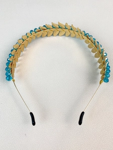 Detailed shot of golden leaf crown headband with deep blue crystal beads and alloy craft