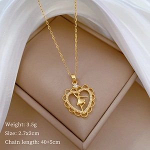 Close-up of golden ballet dancer heart pendant with dimensions 2.7x2cm and weights 3.5g