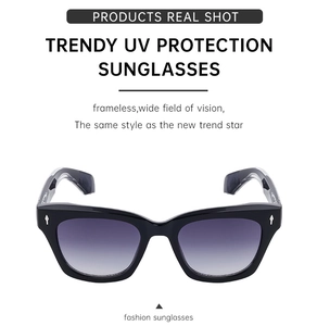 Detail view of sport sunglasses featuring black frames and purple gradient lenses