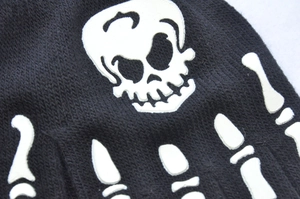 Close-up of skeleton hand bone print on black knitted half-finger cycling gloves