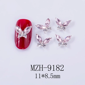 Macro detail of 3D silver alloy butterfly nail charms with pink gems, 11x8.5mm size