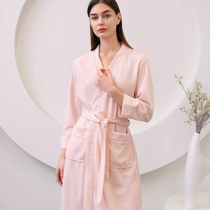 Pink waffle knit bathrobe for women featuring V-neck design and stylish white piping detail