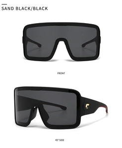Detail of matte black shield sunglasses featuring golden C-logo and oversized lenses