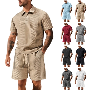 Detail of waffle textured men's polo shirt and shorts set in multiple color variations