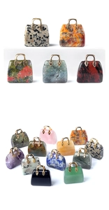 Detailed macro view of assorted natural crystal mini handbag charms with gold metal handles
