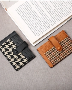 Detail of vintage houndstooth card holders with snap button and multiple slots