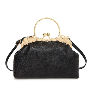 Retro black shell bag with floral embossing and gold metal frame handle