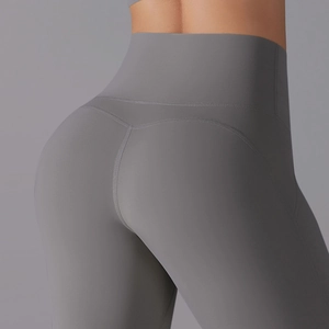 Close-up of high-waisted gray yoga pants featuring butt-lifting seams and matte fabric