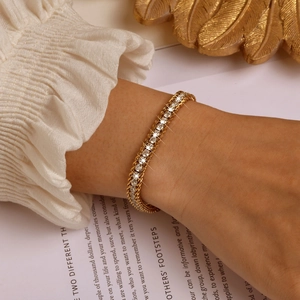 Close-up of three-layer 18K gold-plated chain bracelet with round zircons on a model wrist