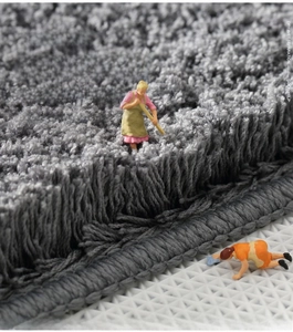 Macro shot of thick grey plush bathroom mat with high-density fibers and non-slip backing