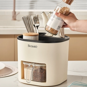 Rotating beige kitchen organizer with knife block, spice jars, and utensil holder