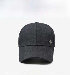 Detailed front view of a dark grey men's baseball cap with denim texture and metal logo