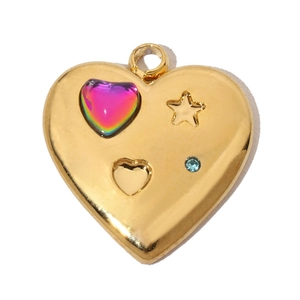 Detail of a vintage heart pendant with a blue rhinestone and colorful star relief