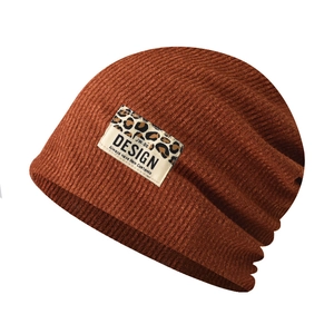 Detailed close-up of the caramel knit beanie texture and the leopard print fabric patch