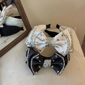 Detail of luxury satin bow headbands with crystal rhinestones in black and white