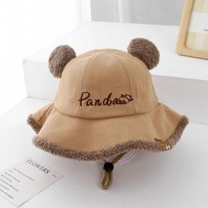Detail of baby corduroy bucket hat with plush ears, lace trim, and adjustable drawcord