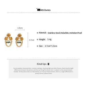 Detail view of gold stainless steel flower earrings with pearl and malachite tassels