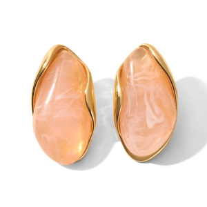 Close-up of pink resin oval earrings with white marbling in golden metal frames
