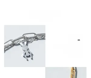 Detail of mechanical rabbit pendant and double-layer titanium steel chain in 18K gold finish