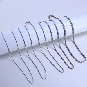 Detail showing various thicknesses of s925 silver twisted rope chains on white display