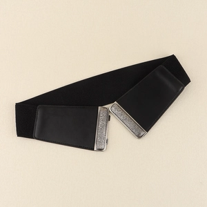 Close-up of black elastic corset belt with vintage embossed silver metal buckle details