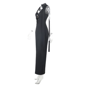 Detail of black backless maxi dress with halter neck and metallic buckle on mannequin