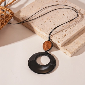 Minimalist long sweater necklace with geometric resin and wood circle pendant on a rope